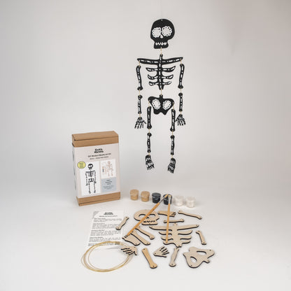 Skeleton mobile kit with pieces and packaging on a white background