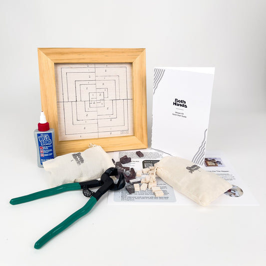 Wooden mosaic frame with printed pattern, pliers, marble tiles, glue and printed instructions, on a white background

